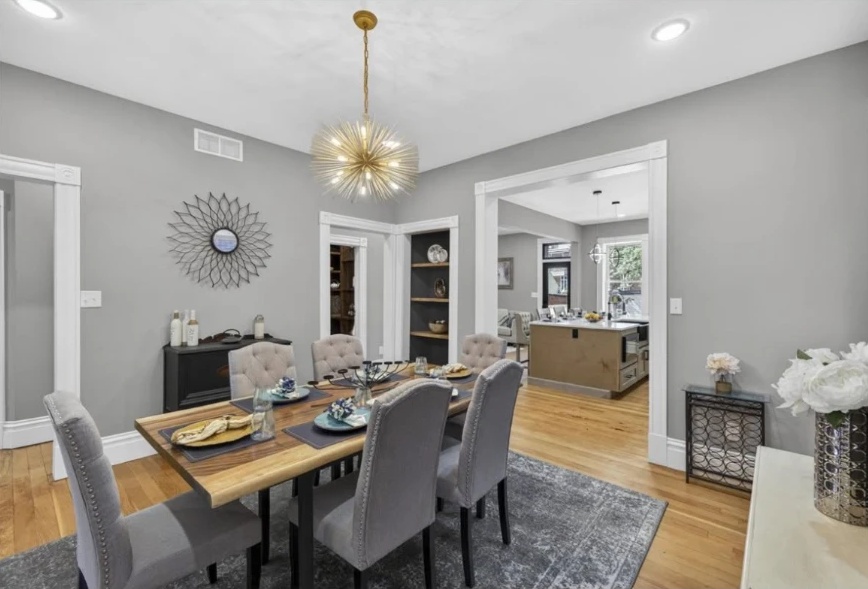 Dining room opening into the kitchen through a wide trimmed doorway