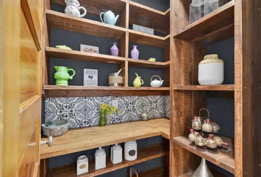 Wood pantry shelves and countertop with decorative patterned tile backsplash
