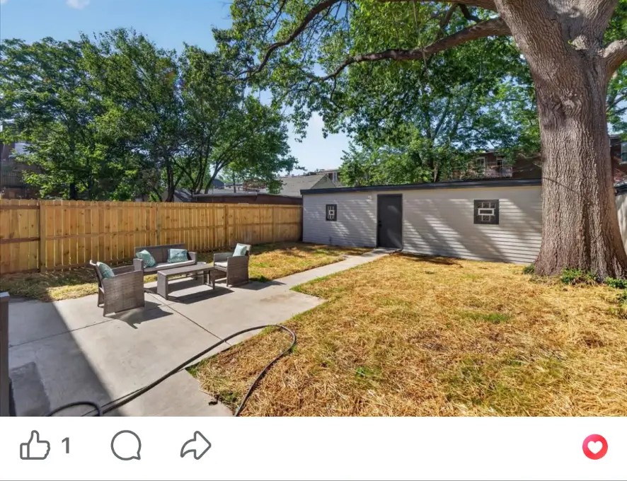 Backyard with concrete patio, outdoor seating, wood privacy fence and gray shed