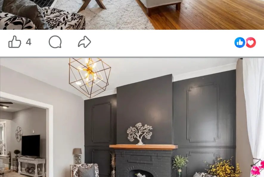 Living room with brick fireplace, geometric chandelier, sofa and view to the front entry